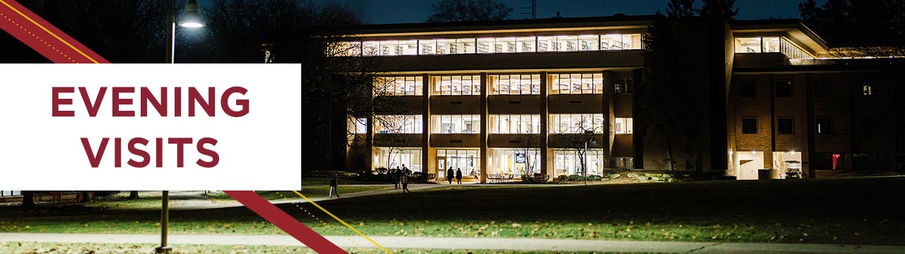The Hekman Library lit at night.